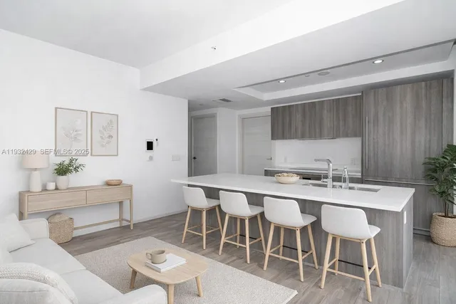 a kitchen with a dining table chairs and white cabinets