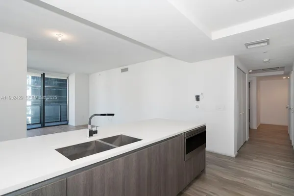 a kitchen with a sink and a refrigerator