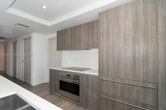 a kitchen with a stove top oven and cabinets