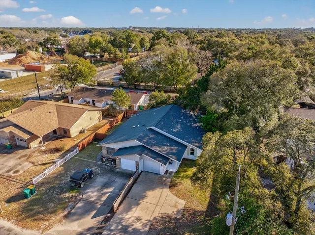 an aerial view of a house with a yard and lake view