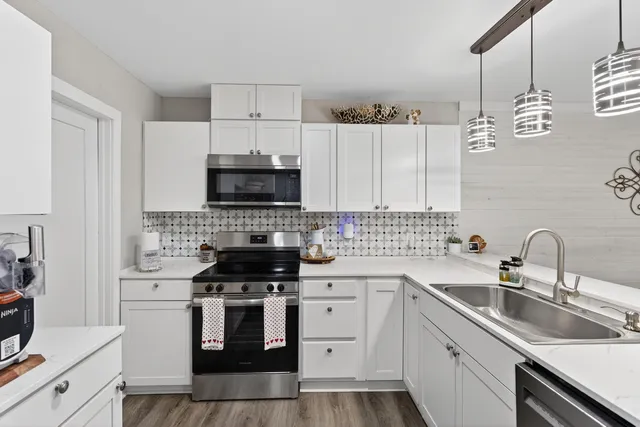 a kitchen with a sink cabinets and stainless steel appliances