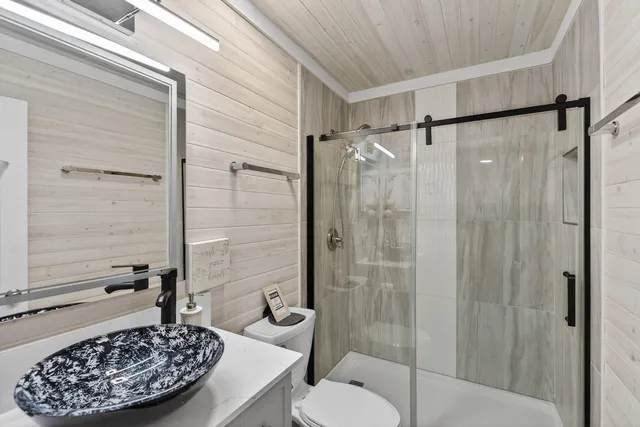 a bathroom with a toilet and a shower