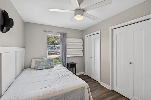 a bedroom with a bed and a flat tv screen