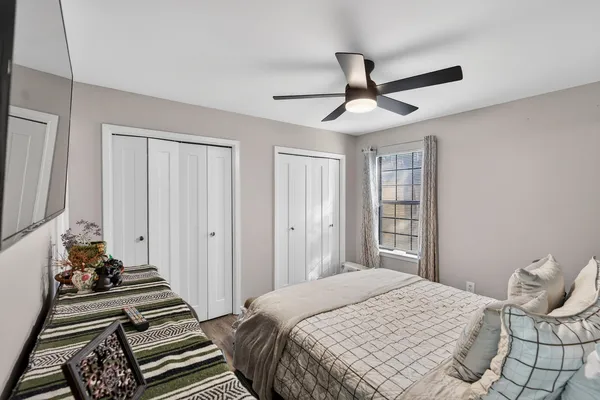 a bedroom with a bed and a chandelier
