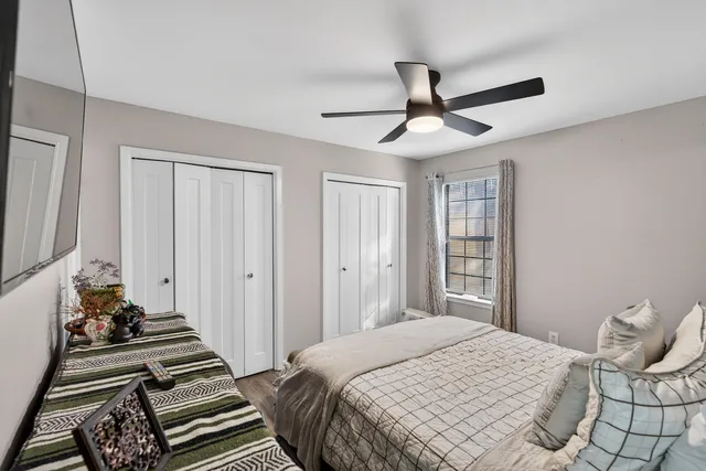 a bedroom with a bed and a chandelier