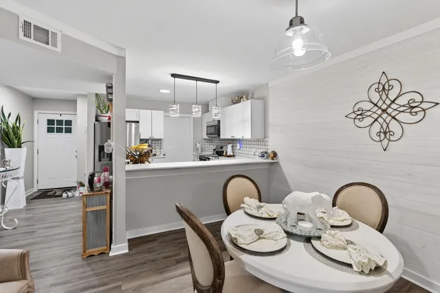 a open dining room with furniture a chandelier