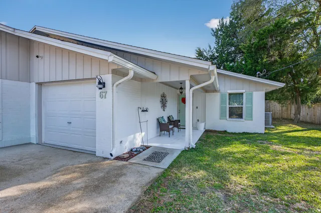 a view of a backyard with a patio and garden