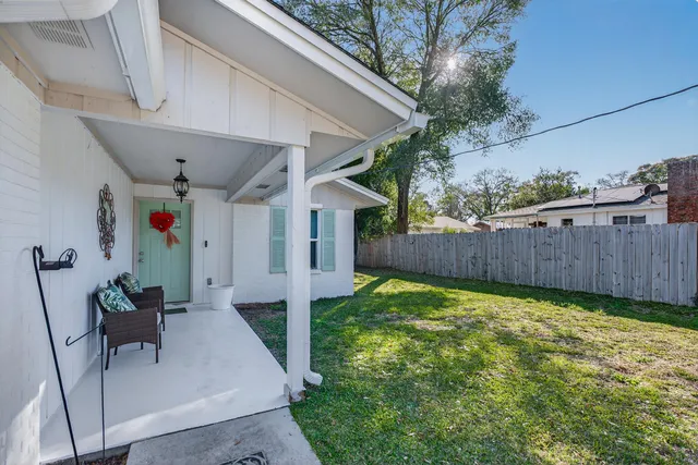 a view of a backyard with a small cabin and furniture