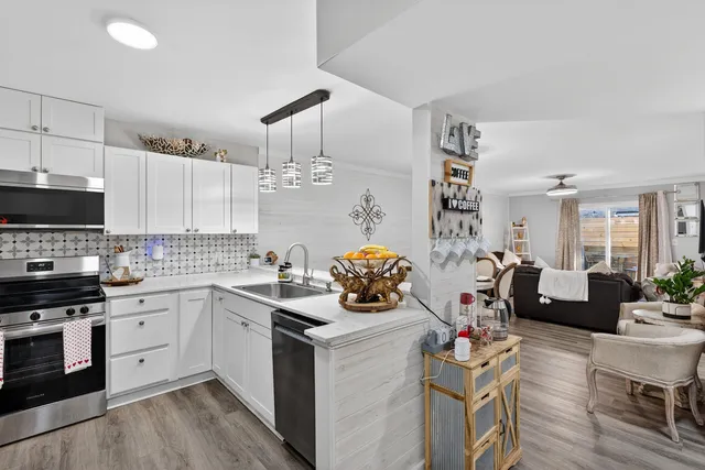 a kitchen with a sink stove and cabinets