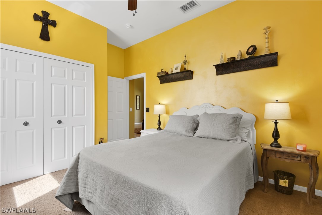 12831 Timber Ridge Drive Fort Myers, FL 33913 - Photo 12 of 16 a bedroom with a bed and a painting on the wall