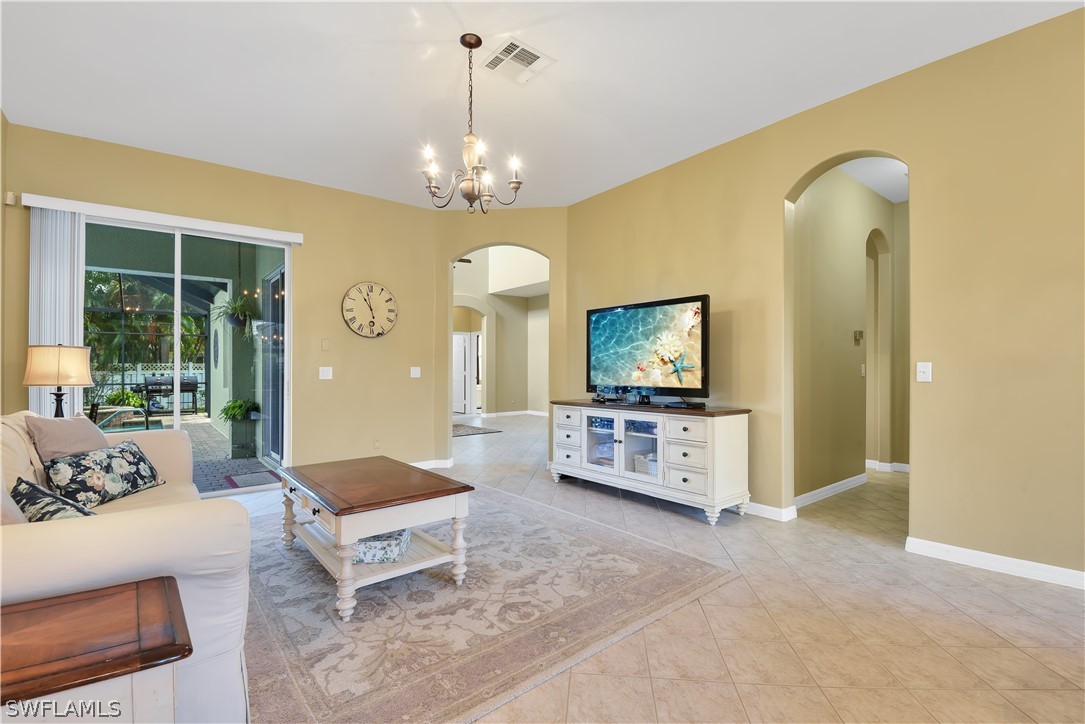 12831 Timber Ridge Drive Fort Myers, FL 33913 - Photo 7 of 16 a living room with furniture and a flat screen tv