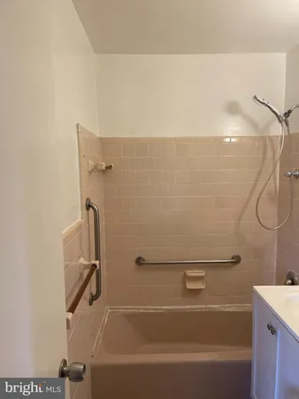 a bathroom with a shower and a bath tub