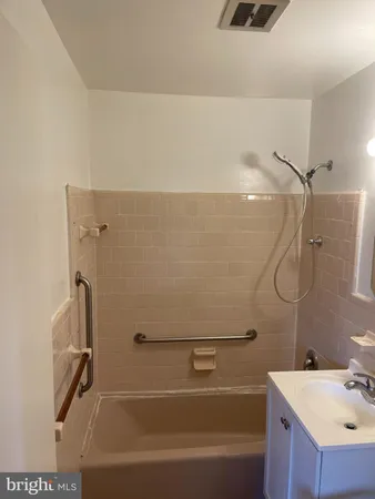a bathroom with a shower and a sink