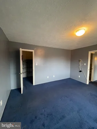 a view of an empty room with a fireplace