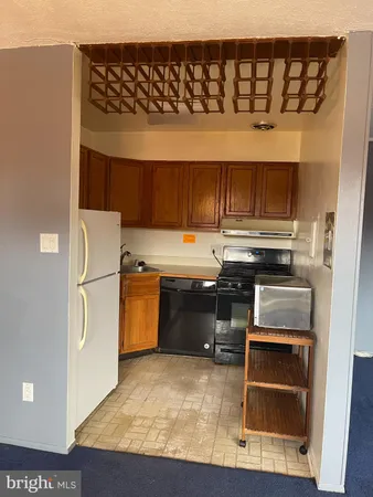 a kitchen with a stove and a refrigerator