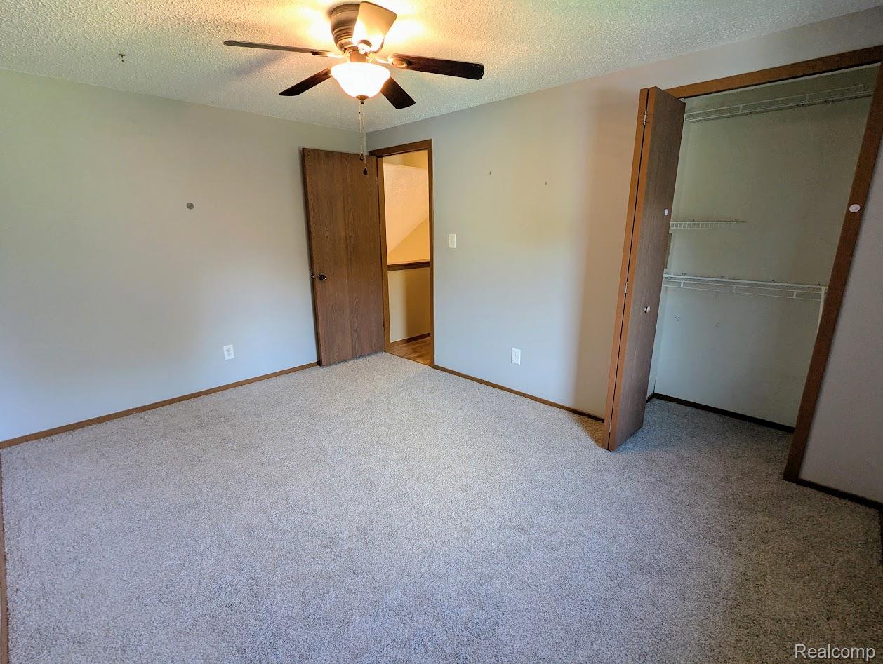 2316 Crescent Lake Road Waterford, MI 48329 - Photo 8 of 17 Neutral-toned walls complement light-colored carpeting