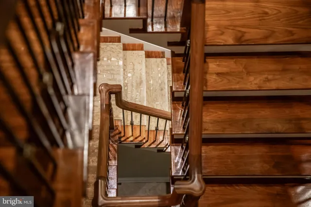 a dining room with wooden floor a chandelier a wooden table and chairs