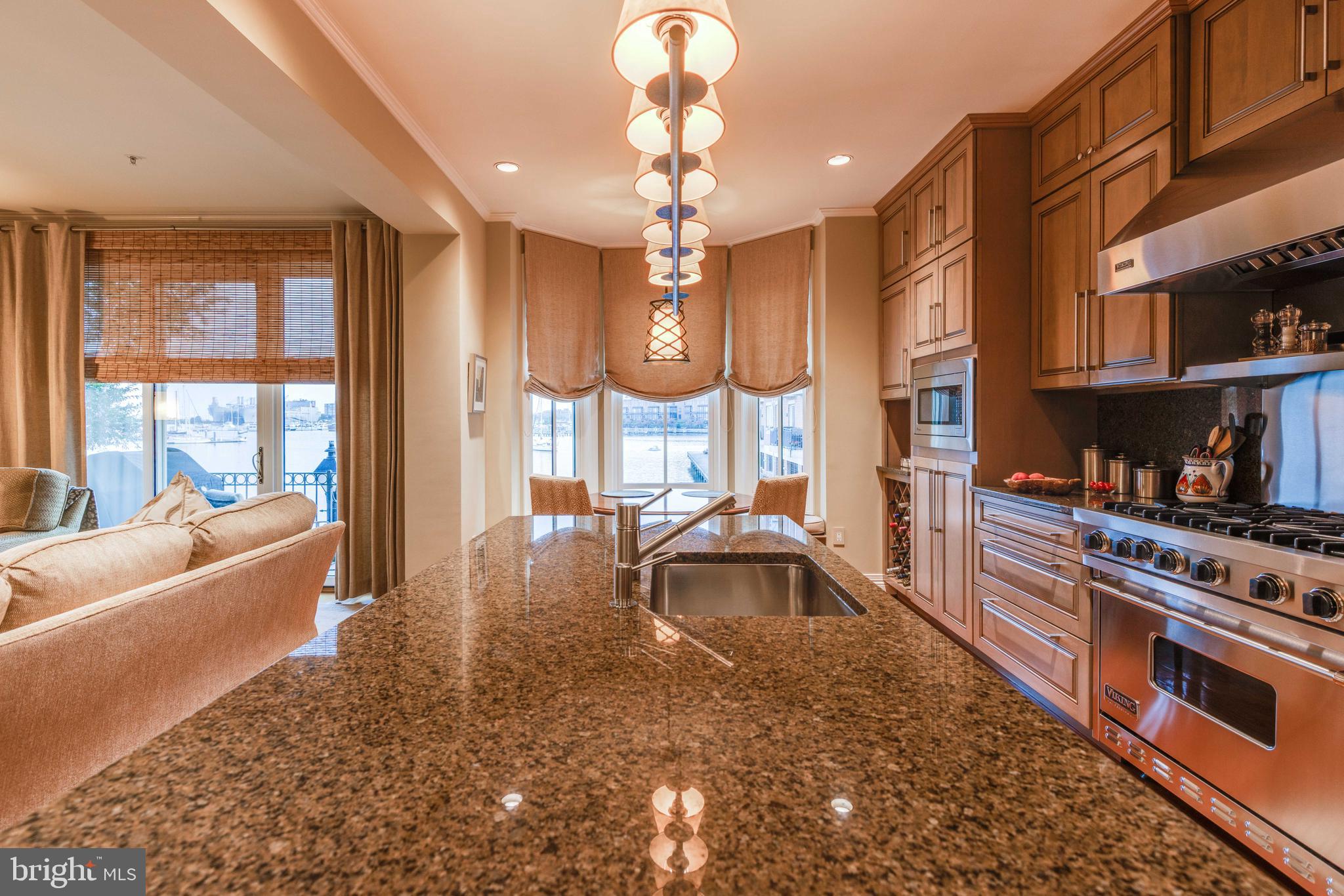 2325 Boston Street, Unit 2 Baltimore, MD 21224 - Photo 15 of 48 a large white kitchen with sink a counter top space and living room view