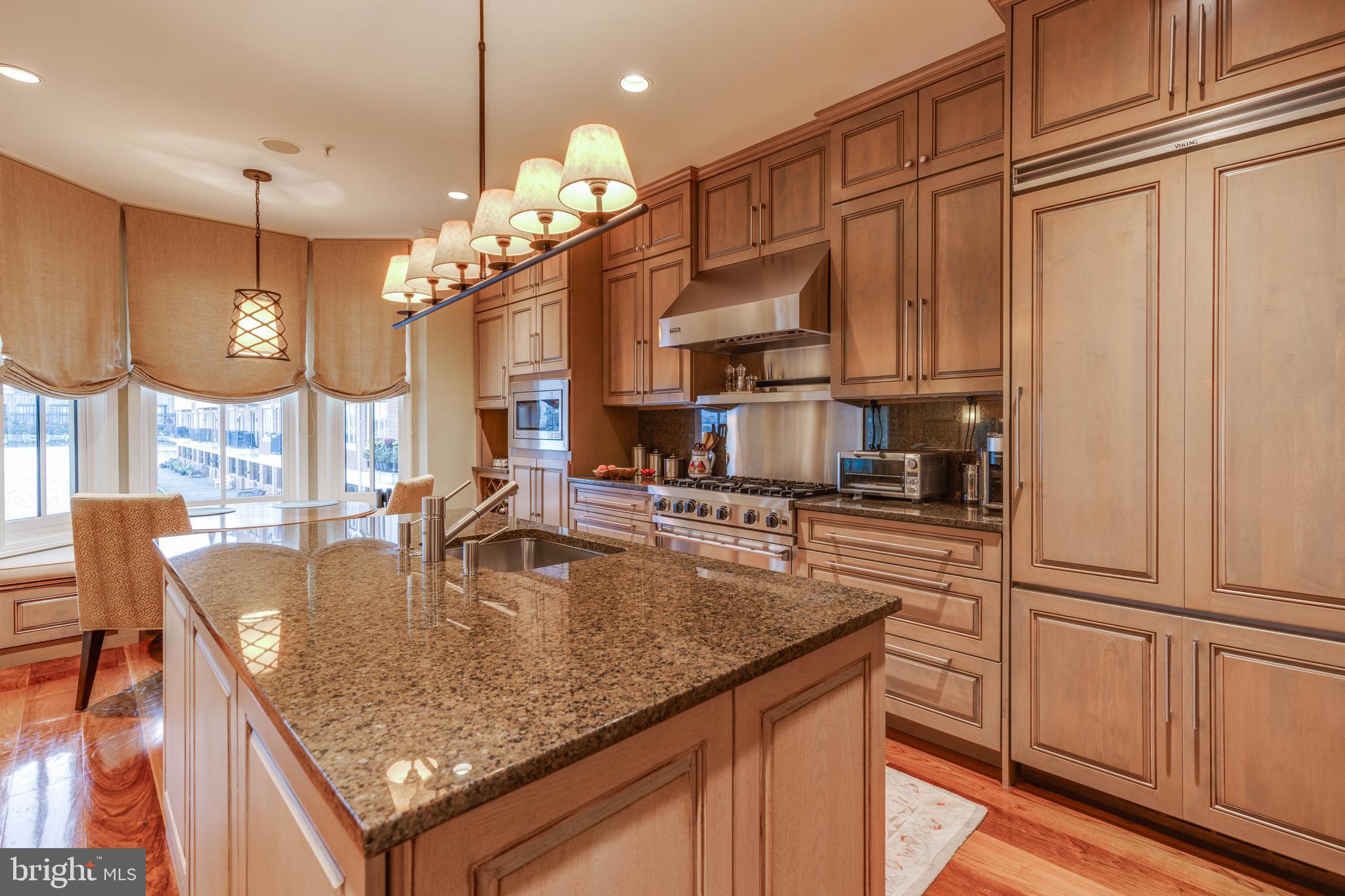 2325 Boston Street, Unit 2 Baltimore, MD 21224 - Photo 20 of 48 a kitchen with stainless steel appliances granite countertop a sink dishwasher and cabinets with wooden floor