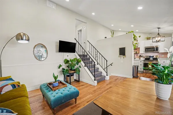a living room with furniture a clock and a window