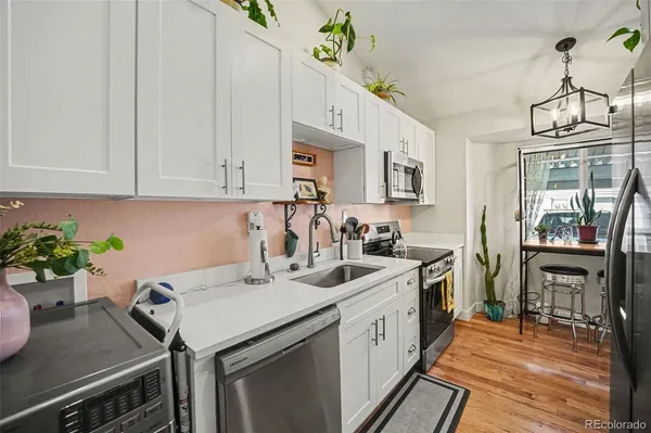 a kitchen with a sink stove and cabinets