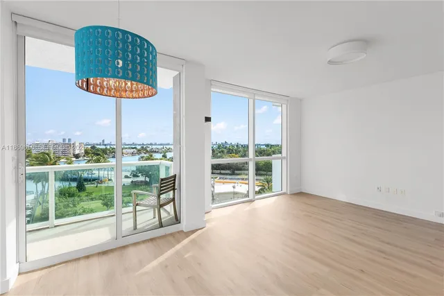 a kitchen with stainless steel appliances granite countertop a sink and a refrigerator
