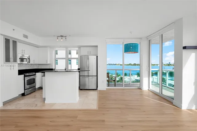 a kitchen with granite countertop a sink and a stove top oven