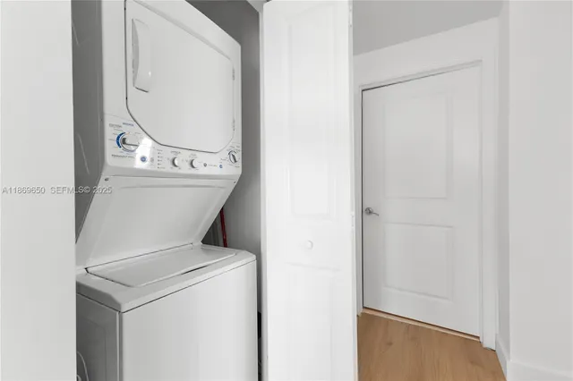 a bathroom with a granite countertop sink a toilet a mirror and bathtub