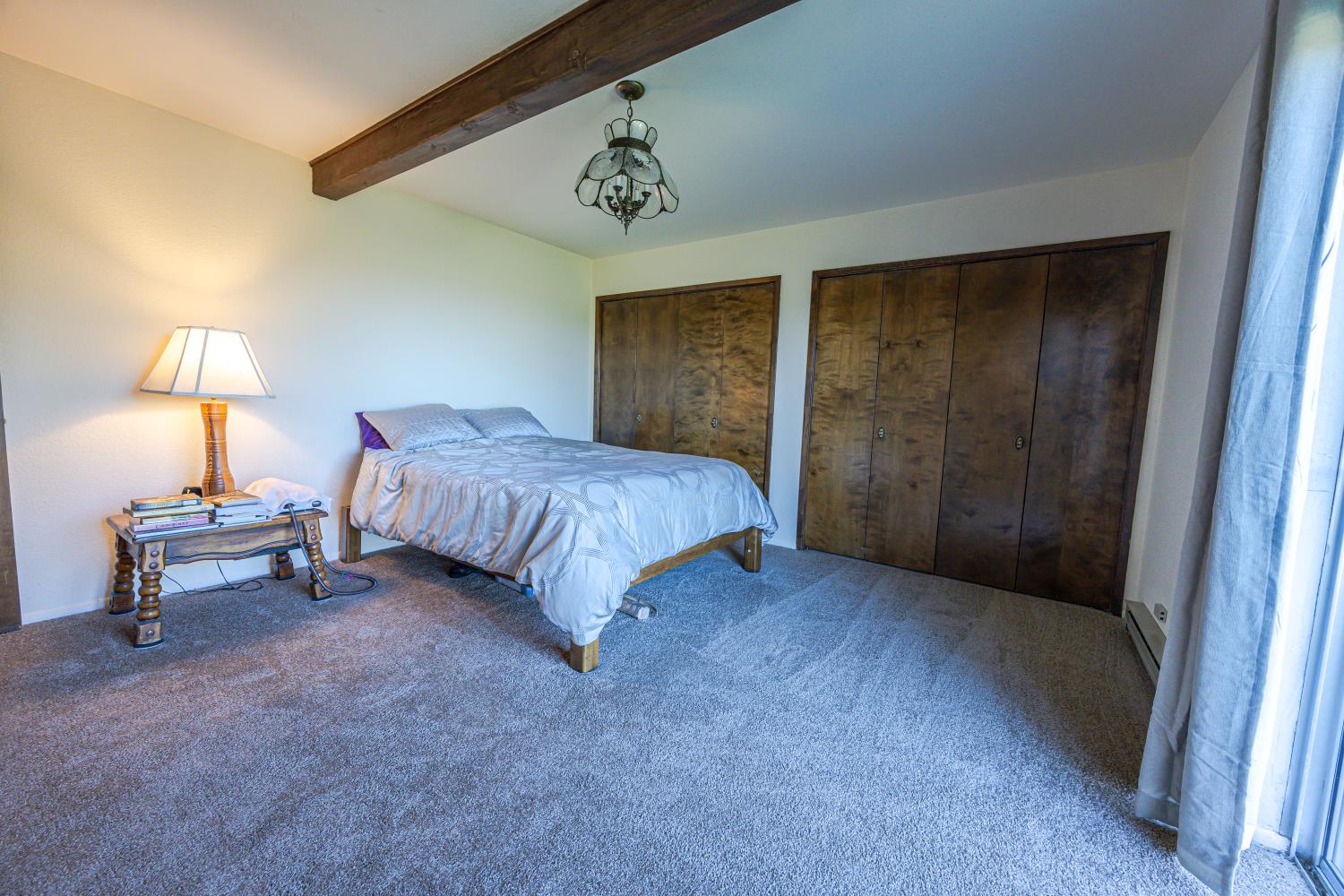 34107 Memory Lane Coarsegold, CA 93614 - Photo 11 of 46 a bedroom with a bed and a lamp