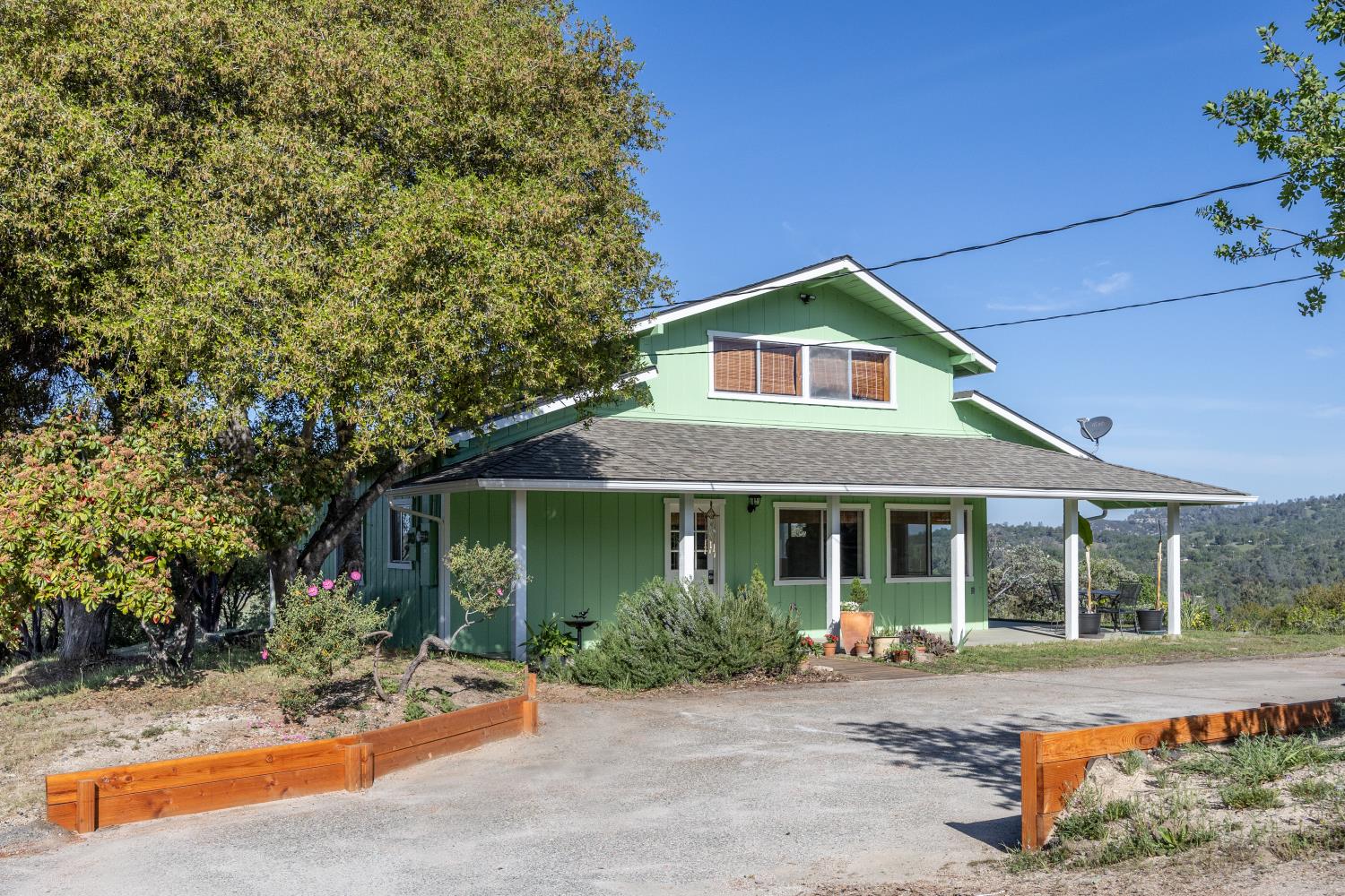 34107 Memory Lane Coarsegold, CA 93614 - Photo 25 of 46 a front view of a house with a yard and porch