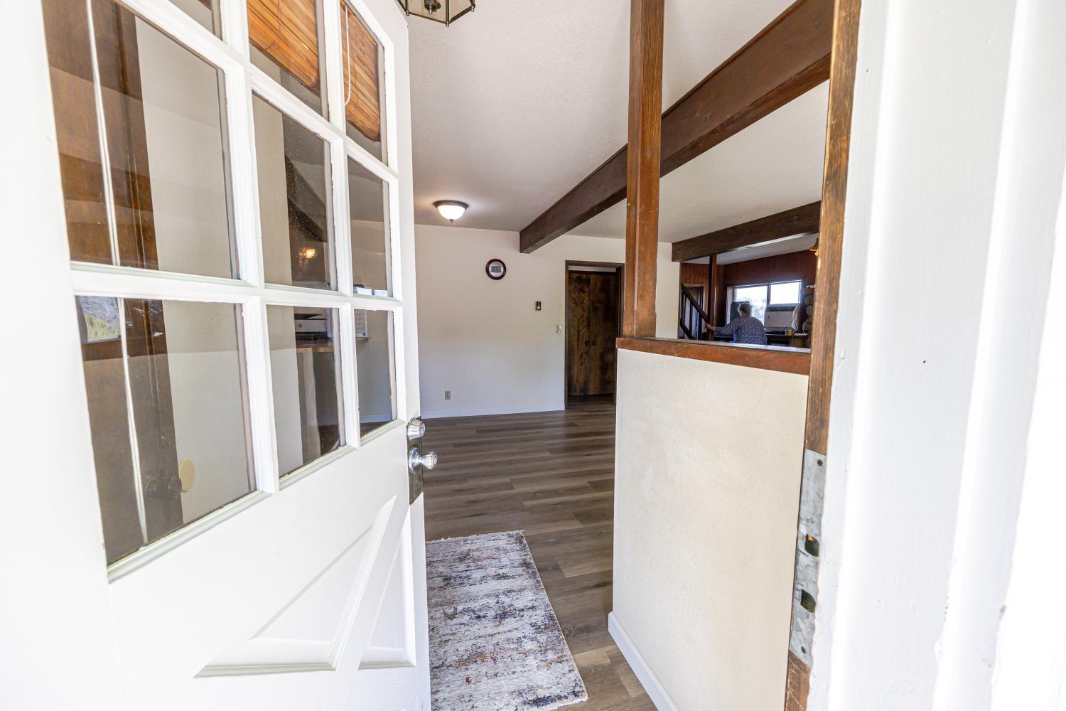 34107 Memory Lane Coarsegold, CA 93614 - Photo 5 of 46 a view of a hallway with wooden floor and staircase