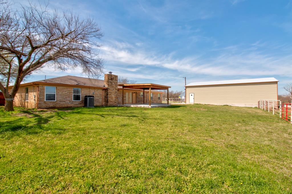 3884 Lois Road East Sanger, TX 76266 - Photo 2 of 40 a front view of a house with a garden