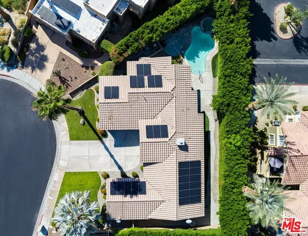 an aerial view of a house with a yard and potted plants