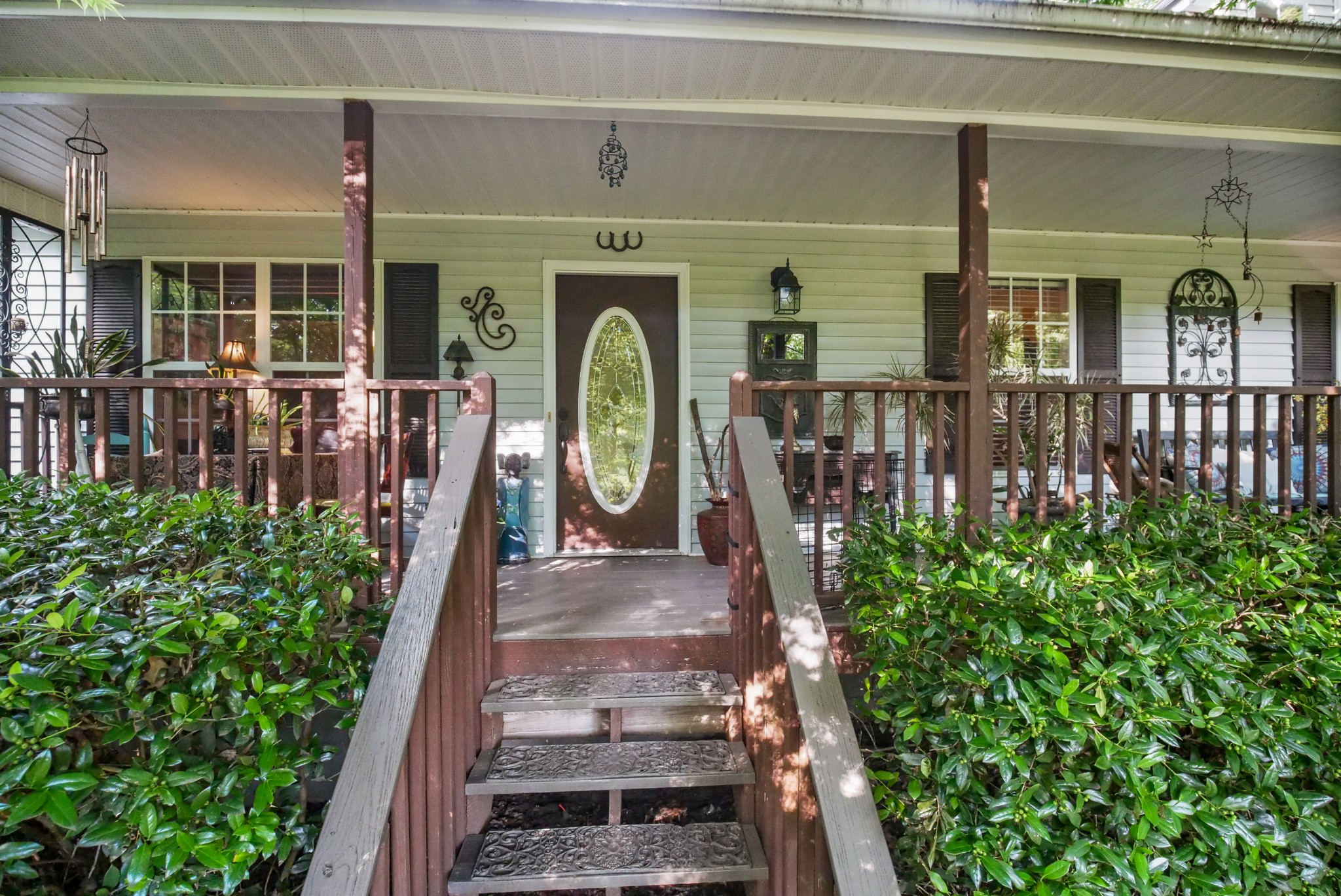 a view of a house with large windows and flower plants