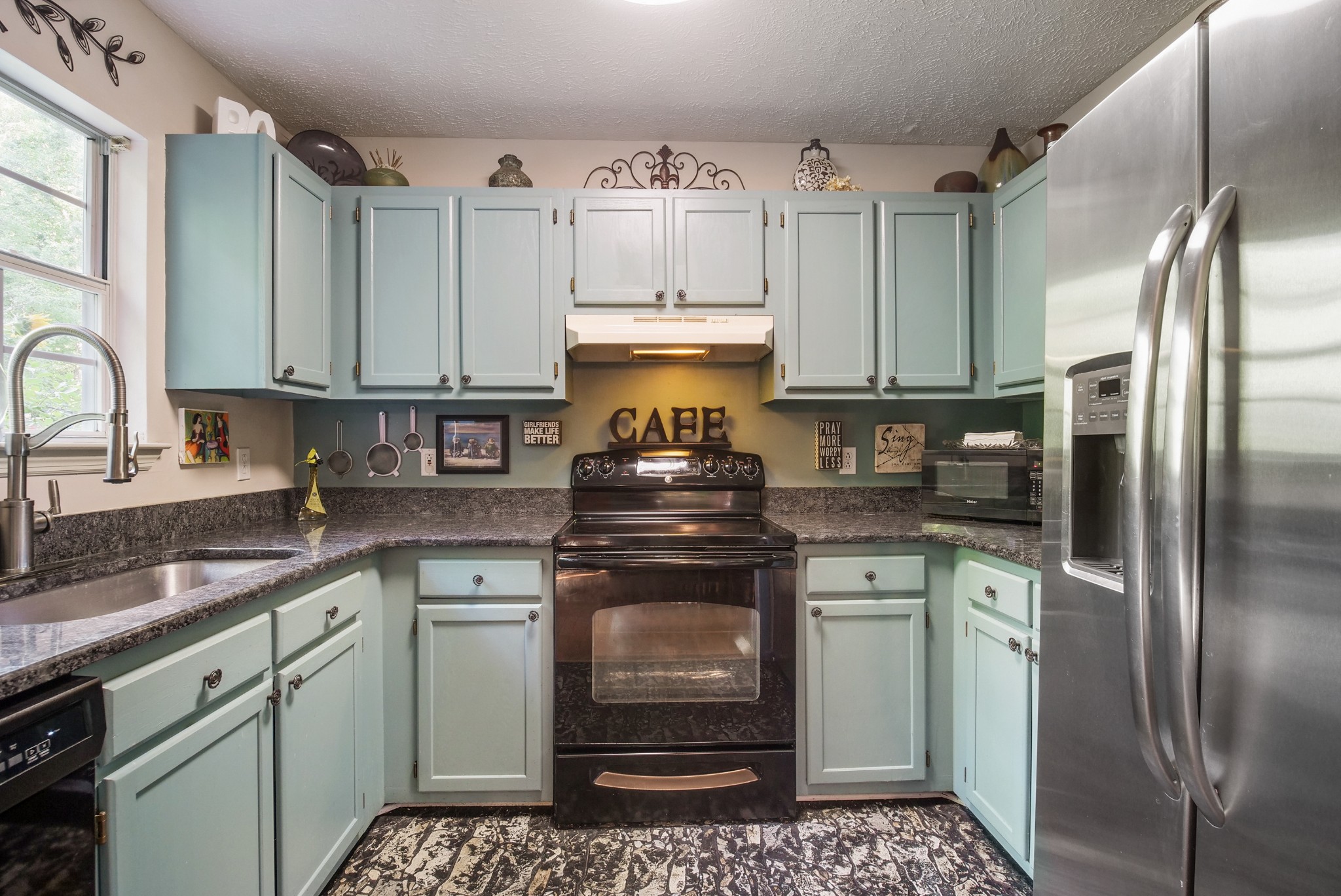 137 Gaskins Road Dickson, TN 37055 - Photo 14 of 38 a kitchen with a stove refrigerator and cabinets