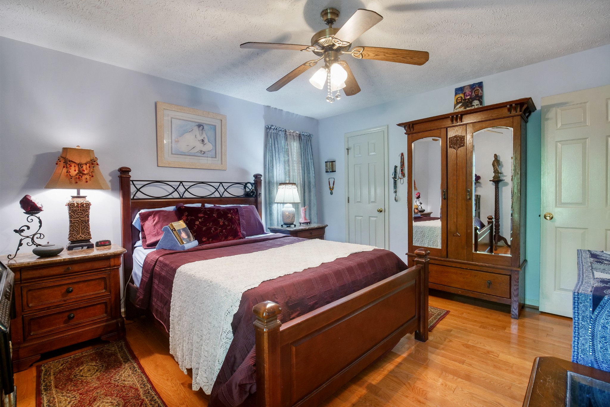 137 Gaskins Road Dickson, TN 37055 - Photo 16 of 38 a bed room with a bed and a chandelier