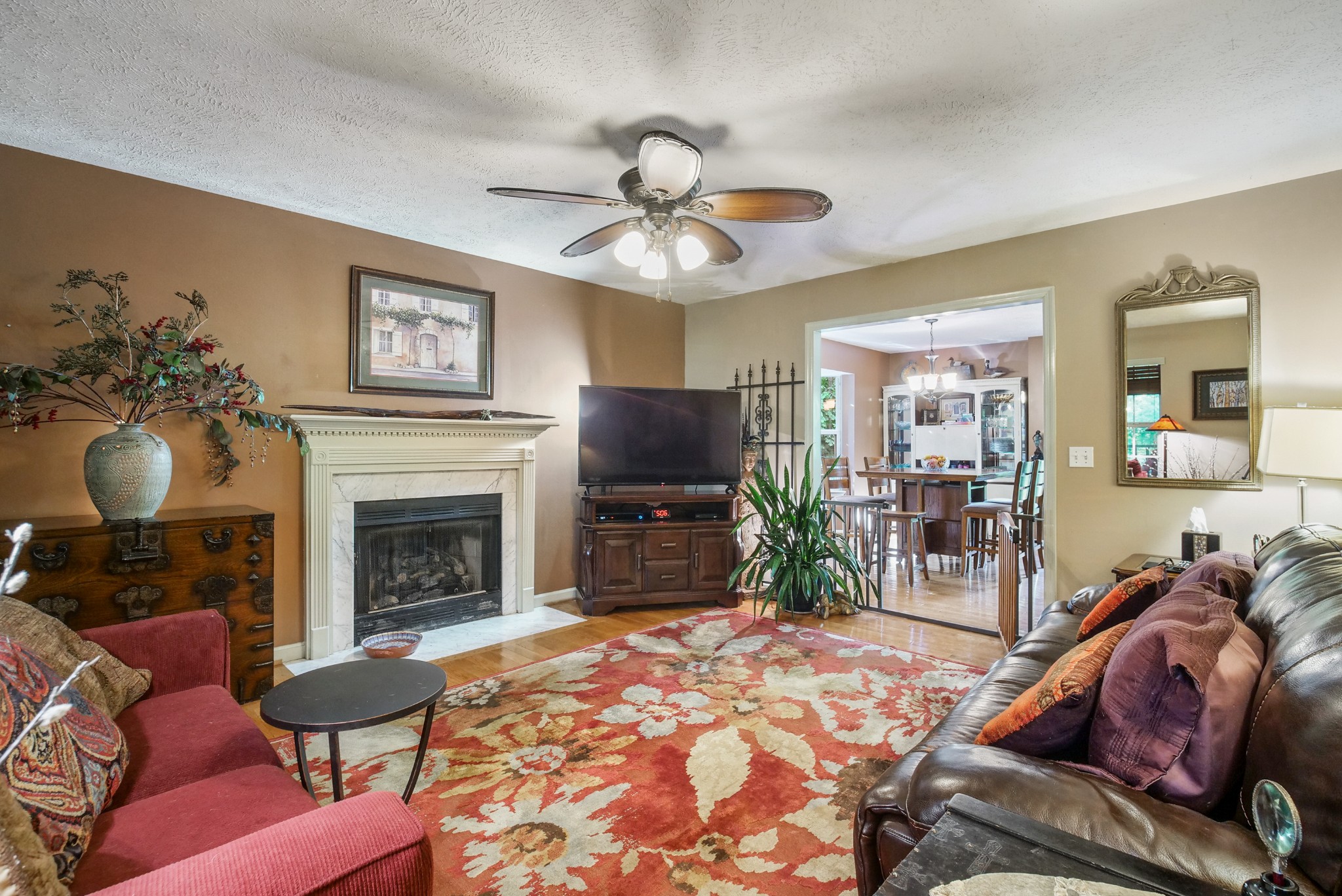 137 Gaskins Road Dickson, TN 37055 - Photo 10 of 38 a living room with furniture a flat screen tv and a fireplace