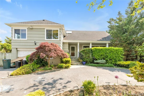 a front view of a house with a garden