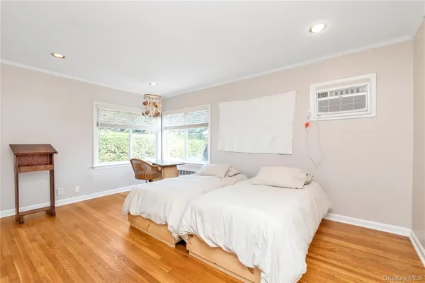 a bedroom with a bed and a large window