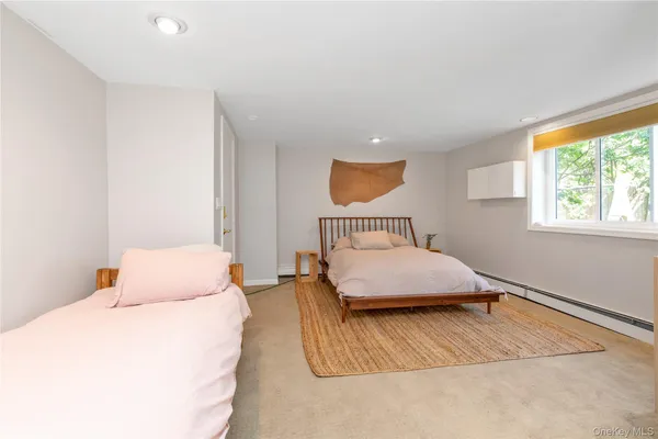 a bedroom with a bed and a night stand