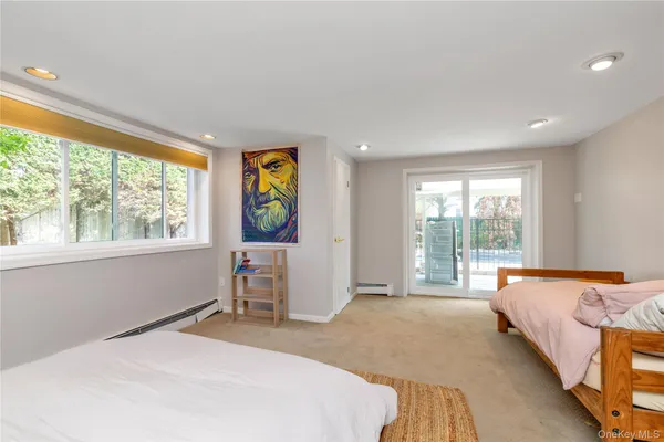 a bedroom with a bed and large windows