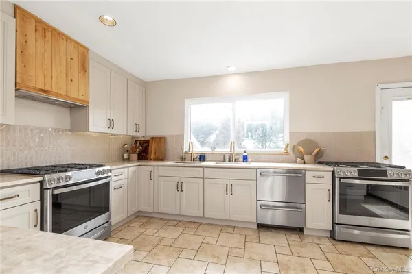 a kitchen with a stove sink and cabinets