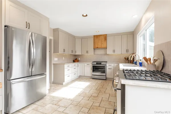 a kitchen with stainless steel appliances a refrigerator sink and stove