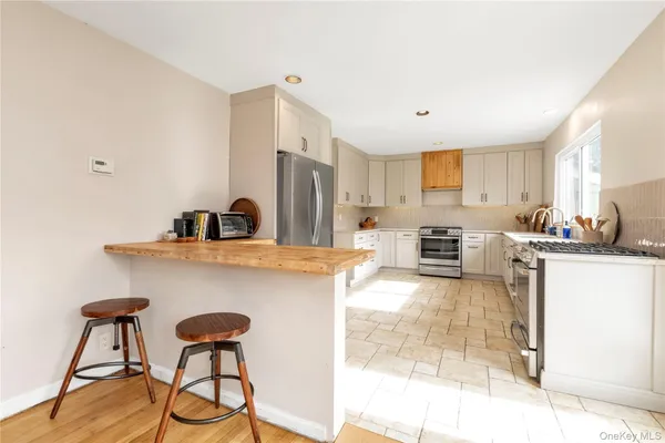 a kitchen with stainless steel appliances granite countertop a sink and a refrigerator
