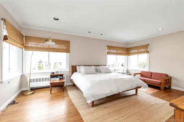 a bedroom with a bed and a large window