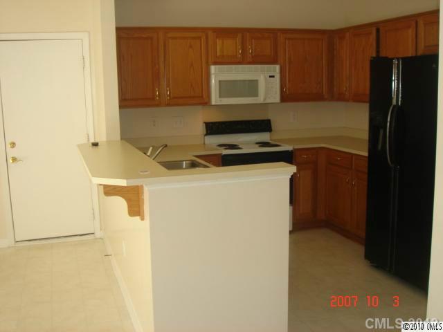 9328 Culcairn Road Huntersville, NC 28078 - Photo 2 of 8 a kitchen with a refrigerator stove and microwave