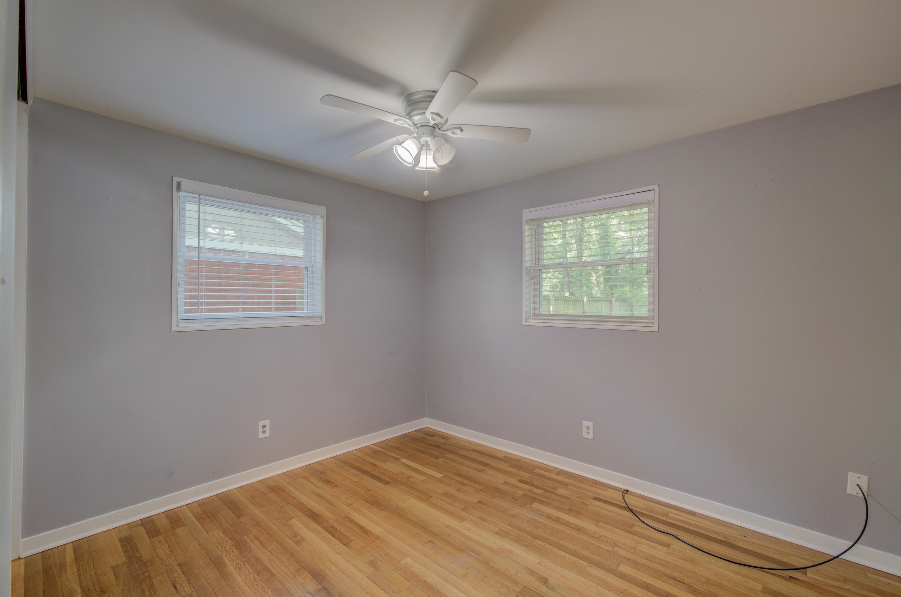 1059 Wellsville Road Memphis, TN 38117 - Photo 14 of 20 a view of an empty room with wooden floor and a window