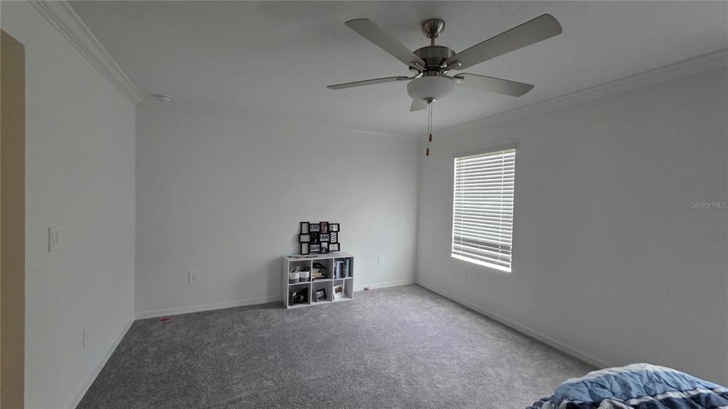 36352 Wl Hl Way Zephyrhills, FL 33541 - Photo 22 of 32 an empty room with a window and a ceiling fan