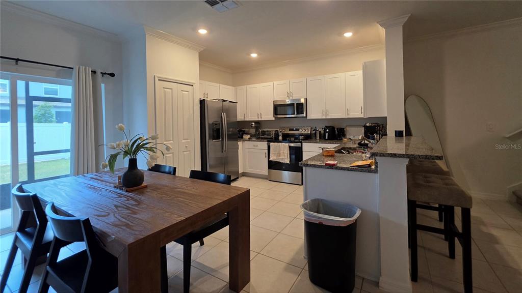 36352 Wl Hl Way Zephyrhills, FL 33541 - Photo 5 of 32 a kitchen with a table chairs and wooden floor