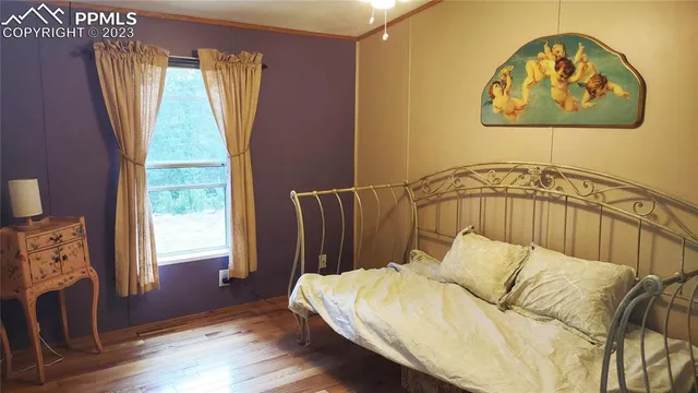 a bed sitting in a bedroom next to a window